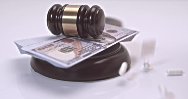Pills and can of pills falling on a judges gavel on a white background. Concept For Medical Negligence, Bail, Monetary Compensation, Drugs Falsification - Footage, Video