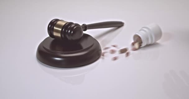 Pills and can of pills falling on a judges gavel on a white background. Concept For Medical Negligence, Bail, Monetary Compensation, Drugs Falsification - Materiał filmowy, wideo