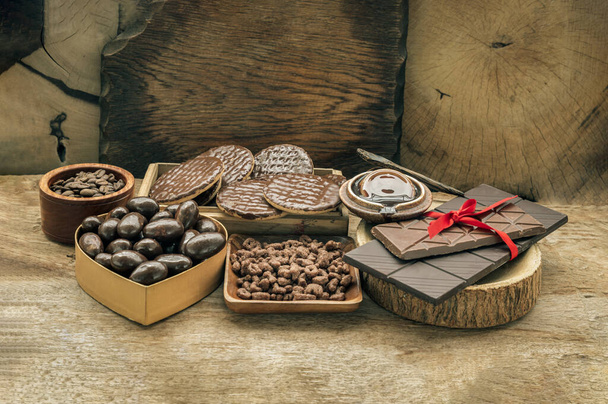 Composition of different Dark chocolate bars and pieces, Melted chocolate and Coffee beans on Old wooden background. Space for text, Selective Focus. - Zdjęcie, obraz