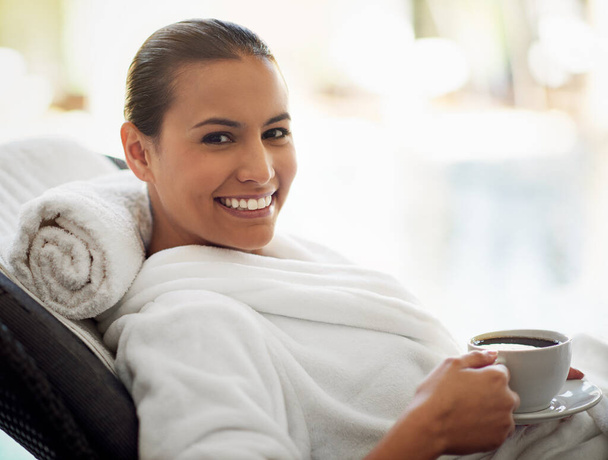 Now this is living. a young woman drinking a cup of coffee at the day spa - Photo, Image