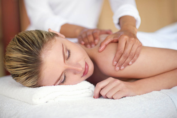 This is absolute bliss. a young woman enjoying a massage at the spa - Foto, imagen