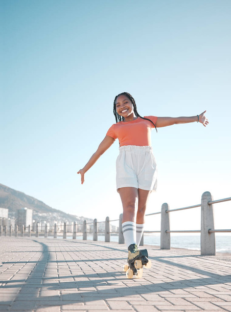 Summer, beach and roller skate woman with happy, relax and calm smile feeling free at the sea. Happiness of a female skater with freedom, movement and fun exercise in the sun in nature by a beach. - Fotó, kép