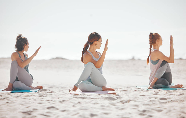 Zen, heath and yoga group meditation on a beach with women training and meditating together. Athletic friends exercise, practice posture and balance yoga pose with zen, peaceful energy in nature. - Zdjęcie, obraz