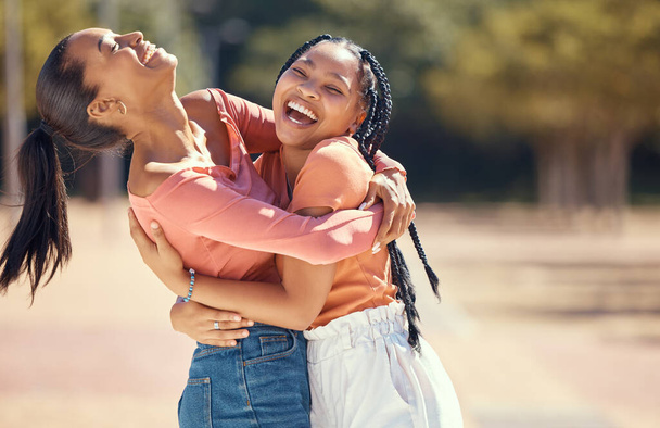 Happy friends or women hug and laugh together in nature at a park or forest. Smiling, playful sisters embracing, bonding, enjoying a day outdoor and showing affection and appreciation in the woods. - Photo, Image