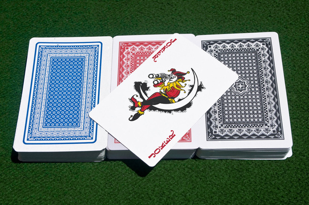 Joker over three decks of cards - Photo, Image