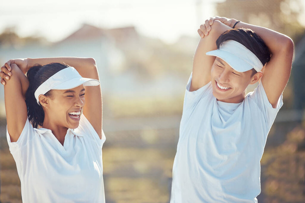 Tennis players stretching arms for a warm up exercise for the joints or muscles for outdoor sport game. Fit, active and happy man and woman athletes preparing for training or practice for a match - 写真・画像