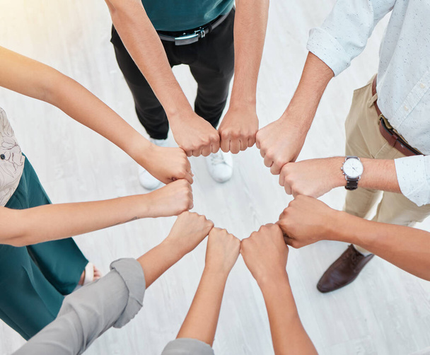 Teamwork, hands and collaboration with a team working together and standing in a huddle in the office. Solidarity, unity or trust and a group of staff with motivation and a goal for company success. - Foto, Imagen