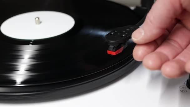 Hand turns on a vintage vinyl record. Vinyl turntable with vinyl plate. Gramophone record player. Retro sound technology to play music - Footage, Video