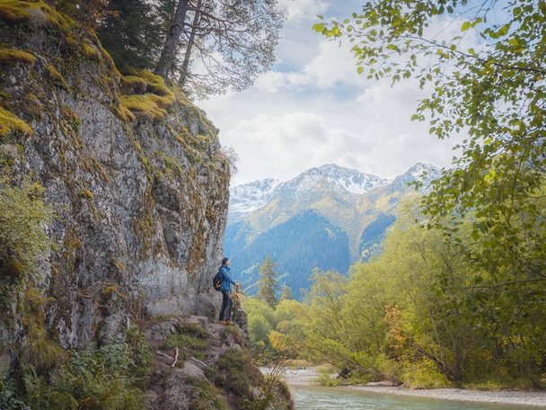 trip to Caucasus mountains, Arkhyz, Teberdinsky reserve. concept of discovery and exploration of wild places in early autumn. woman standing on the river bank - Valokuva, kuva