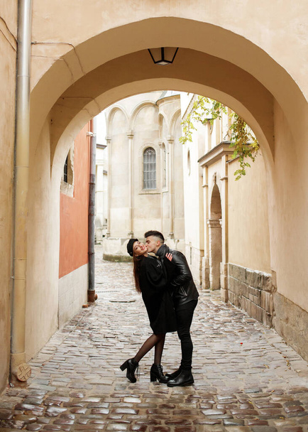 Young couple hugging in the yard of the old town. November 2, 2019, Lviv, Ukraine. - Foto, Imagen