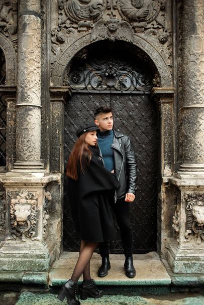 Modern couple posing near a black door. Lviv, Ukraine November 2, 2019 - Foto, Imagen
