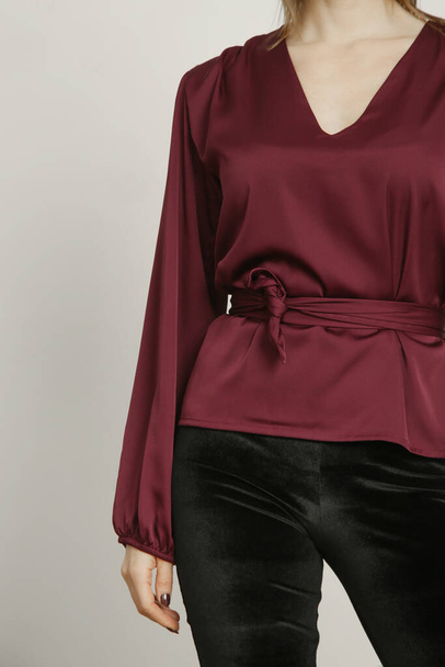 Serie of studio photos portrait of young female model in silk satin burgundy blouse - Photo, Image