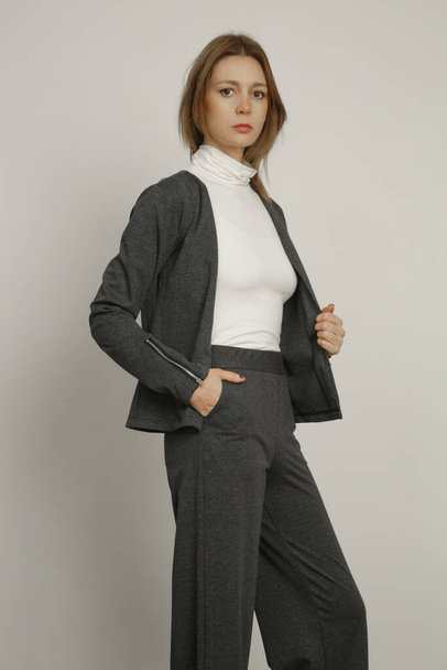 Serie of studio photos of young female model wearing casual business outfit. - Valokuva, kuva
