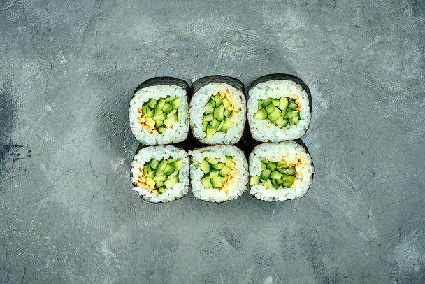 Maki sushi roll with cucumber on a gray background. Selective Focus. Sushi Menu - Foto, immagini