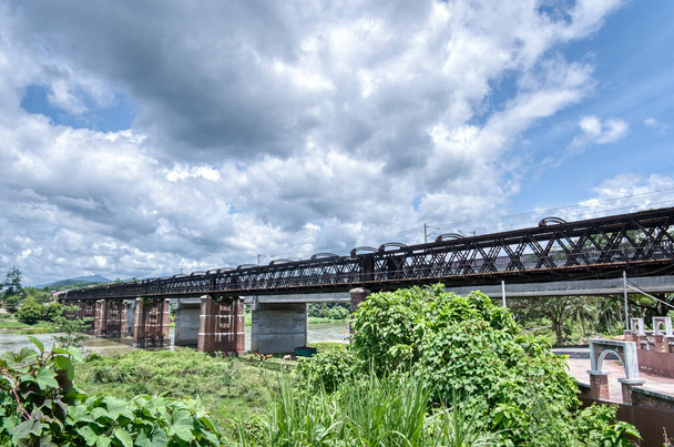 the tall railway bridge crossing the river. - 写真・画像