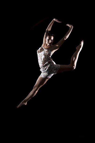 Athletic dancer leaping in air - 写真・画像