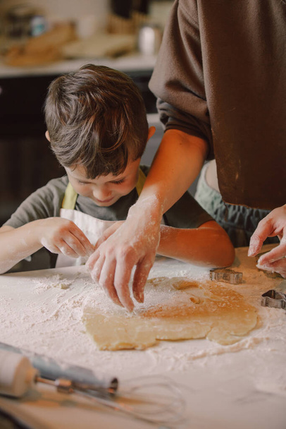 mother and son preparing flour for cookies in the kitchen - Foto, Imagen