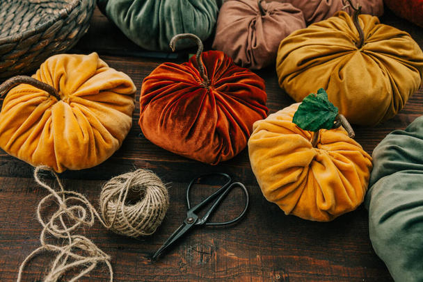handmade pumpkins made of fabric with scissors and rope on wooden table - Φωτογραφία, εικόνα