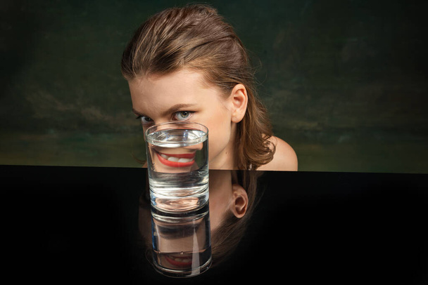 Grimace. Weird emotions, facial expression concept. Modern art photography. Funny weird girls face through glass of water. Object distortion, optical illusion. Minimalistic contemporary art. Poster - Foto, imagen