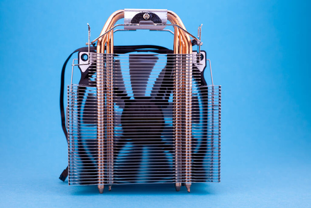 Computer heatsink cooler on blue background. Detail of a personal computer. - Foto, Bild