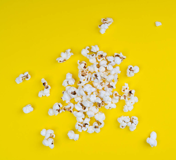 Pop corn on a yellow surface - Photo, Image