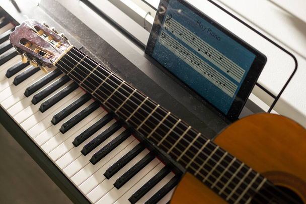 learning music or musical instrument online using tablet at home, persuing hobby. - Fotoğraf, Görsel