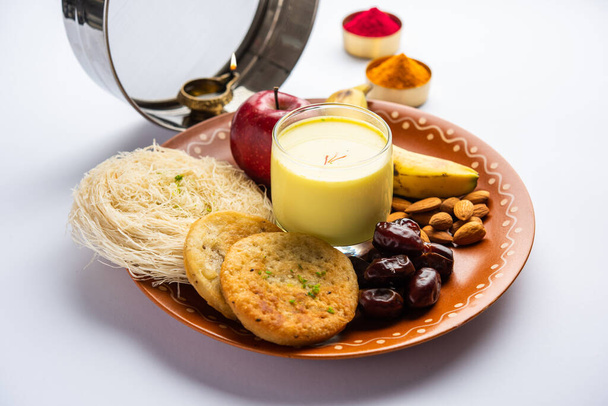 Sargi - pre-dawn meal for karwa chauth or karva chauth puja served with Chalni or strainer and diya - Фото, изображение