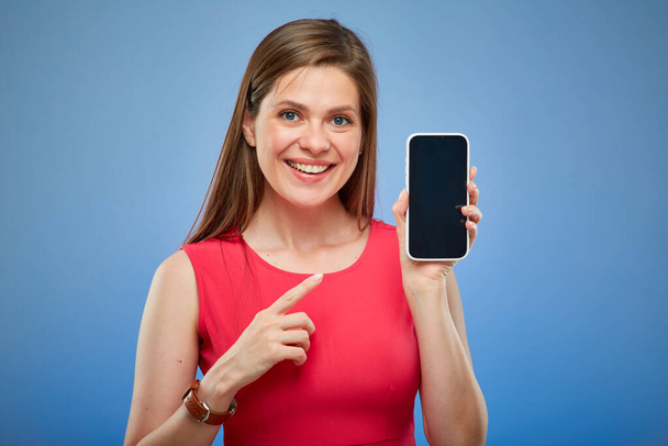 Young happy lady in red dress holding smartphone with credit card, isolated portrait - Фото, зображення