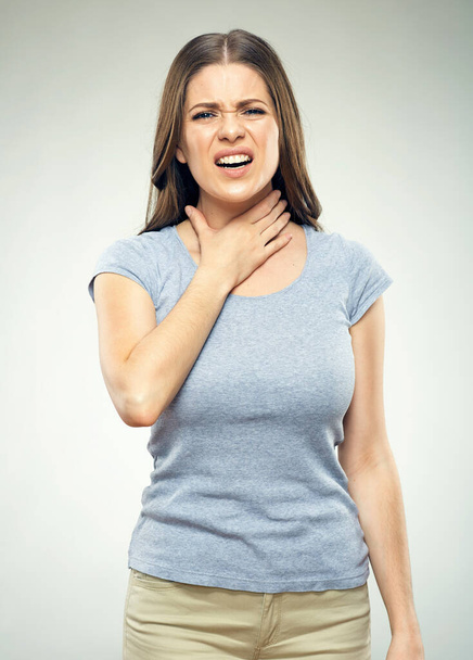 Woman with sore throat, pain. Face with pain suffering. Isolated portrait of woman touching throat. Sore throat from a cold.  - Foto, imagen