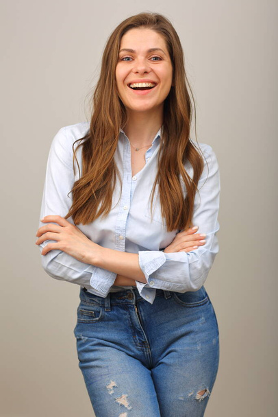 Happy woman with long hair in blue shirt standing with arms crossed. isolated portrait of casual wearing smiling girl. - Foto, Imagen