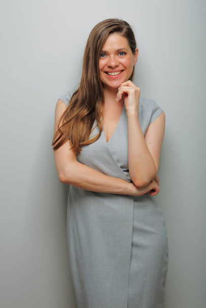 Smiling business woman in gray long dress. isolated female portrait. - Fotó, kép