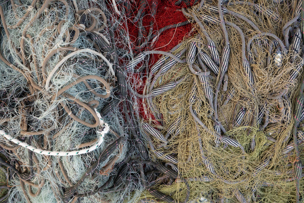 Top down view of colourful fishing nets, yellow, grey, red - Foto, immagini