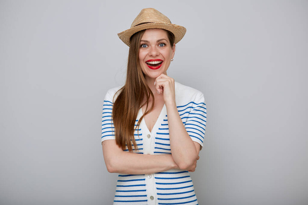 Smiling woman isolated portrait. Girl in white dress with blue stripes and straw summer hat emotional and happy. - Foto, Imagen