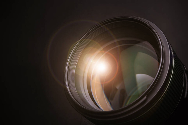Modern camera lens on black background, closeup - Foto, afbeelding