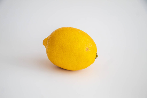 Lemon on the isolated white background, selective focus, noise effect - Photo, image