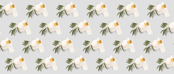 Many bottles of olive essential oil on light background. Pattern for design - Foto, Imagen