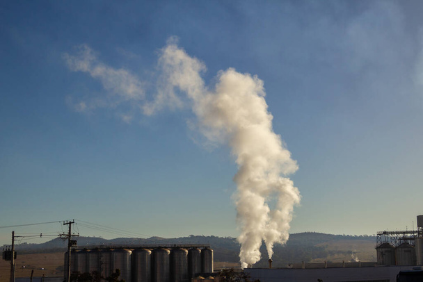 Smoke coming out of the factory chimney. Air pollution from smoke coming out of factory chimneys. - 写真・画像