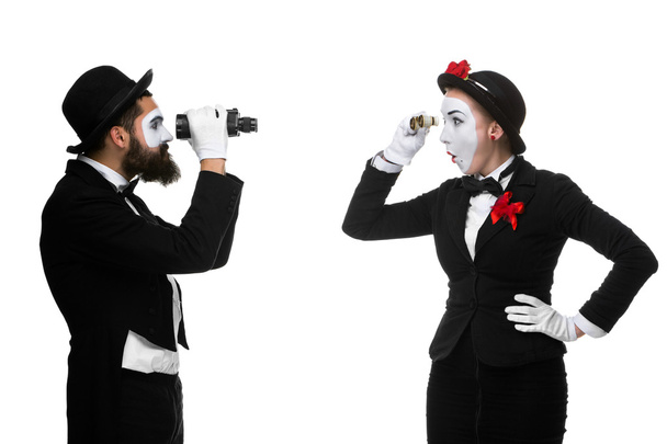 Two memes as business people looking at each other through binoculars - Foto, Imagen