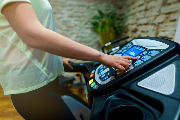 Woman jogging on treadmill at the home gym. - Zdjęcie, obraz