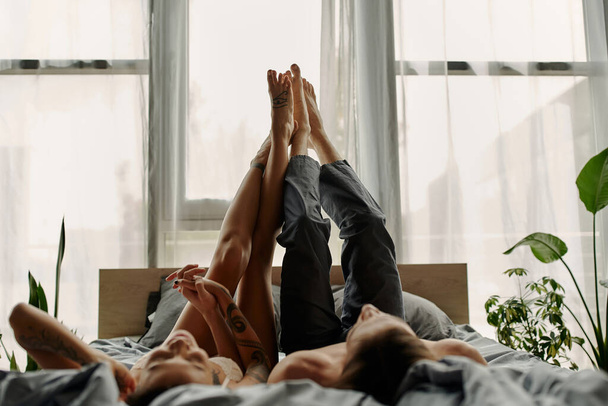 Blurred couple holding hands while lying on bed in morning  - Photo, Image