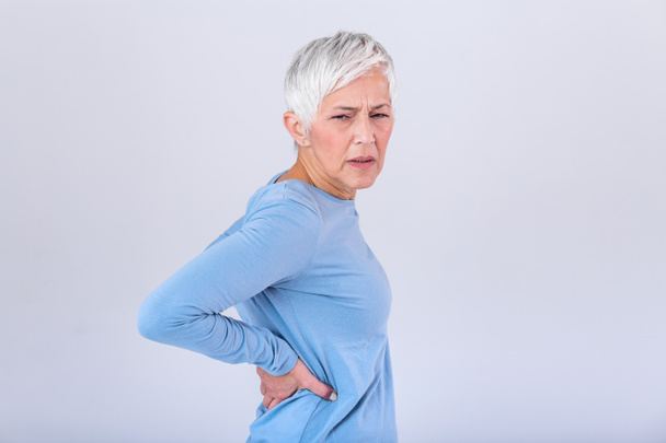 Matur Woman suffering from lower back pain. Mature woman resting with back pain. Female lower back pain. Senior woman injury suffering from backache - Photo, Image