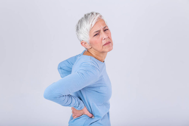 Matur Woman suffering from lower back pain. Mature woman resting with back pain. Female lower back pain. Senior woman injury suffering from backache - Фото, зображення