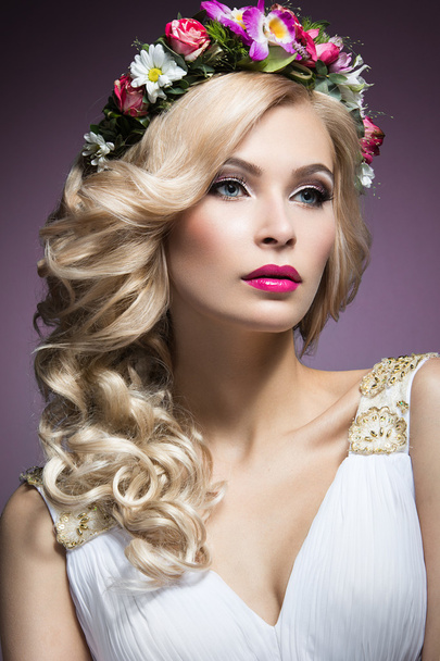 Beautiful blond girl in the image of a bride with flowers in her hair. Beauty face. Wedding image - Foto, imagen