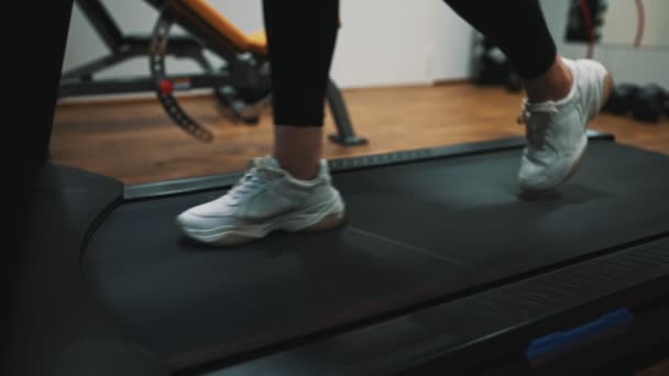 Woman jogging on treadmill at the gym. - Filmati, video