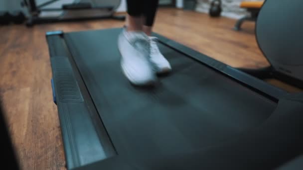 Woman jogging on treadmill at the gym. - Felvétel, videó