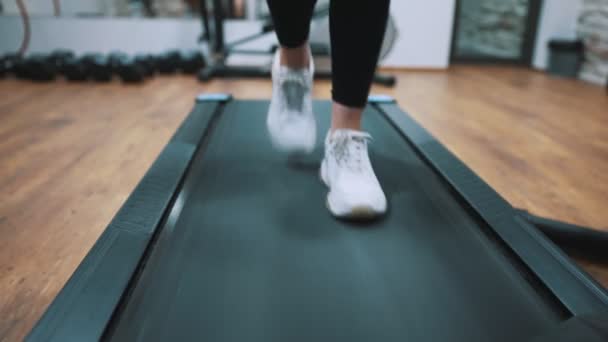 Woman jogging on treadmill at the gym. - Felvétel, videó