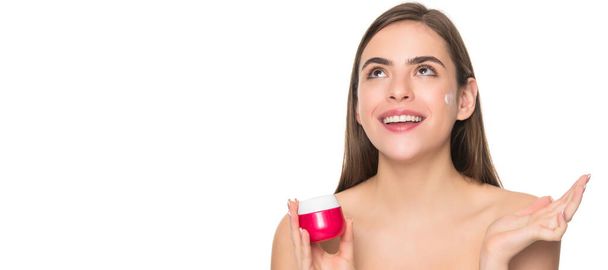 Woman beauty face, close up portrait, isolated banner with copy space. happy young girl applying cream for face skin isolated on white background, healthy skin - Φωτογραφία, εικόνα