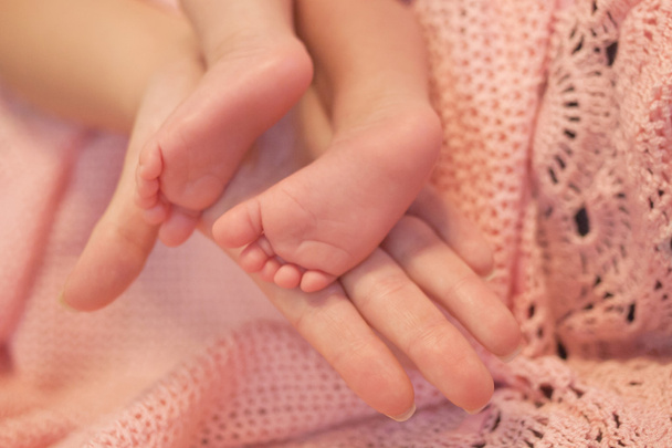 Moederdag hand houden baby voeten  - Foto, afbeelding