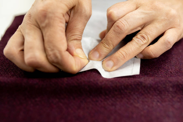 Women's hands sew pieces of fabric on a sewing machine close-up. horizontal frame - Photo, Image