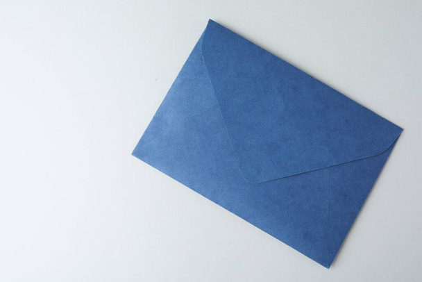 Blue paper envelope on light background, top view - Фото, изображение